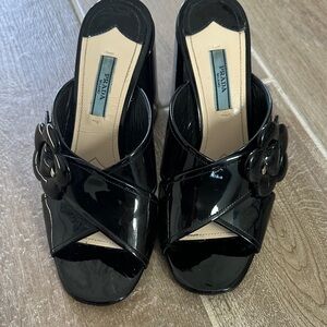 Prada Women's Shiny Black Mules with Floral Accent